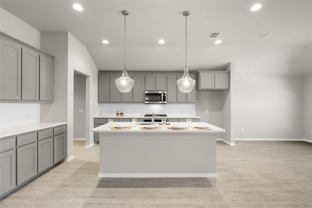 433 Falcon, Azle, TX 76020 - kitchen featuring stainless steel microwave, visible vents, a sink, and gray cabinetry