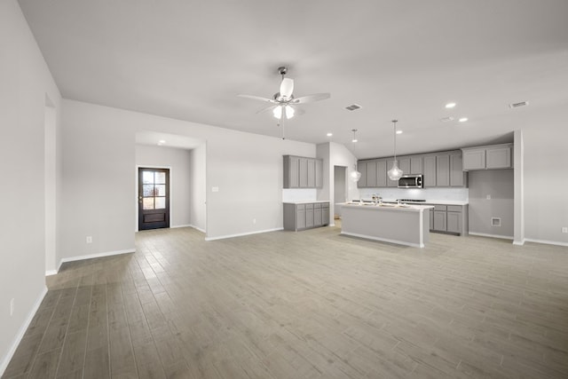 433 Falcon, Azle, TX 76020 - unfurnished living room featuring light wood-style floors, baseboards, and ceiling fan