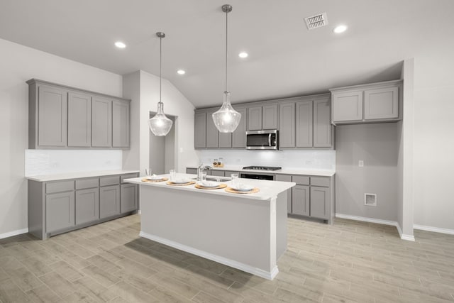 433 Falcon, Azle, TX 76020 - kitchen featuring a sink, light wood-style flooring, stainless steel microwave, gray cabinetry, and visible vents