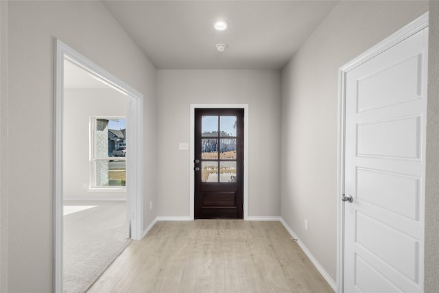 foyer featuring light wood-type flooring and baseboards