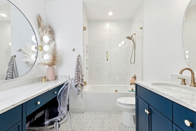 full bathroom featuring tile patterned floors, tiled shower / bath combo, vanity, and toilet