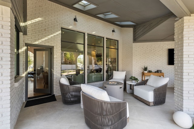 view of patio with an outdoor living space with a fire pit