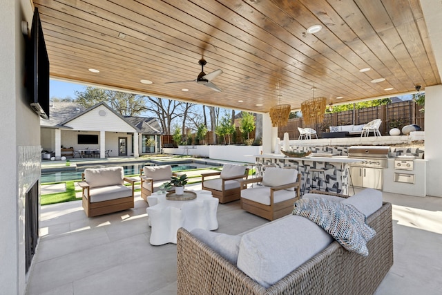 view of patio with outdoor dry bar, grilling area, an outdoor living space, a fenced in pool, and a fenced backyard