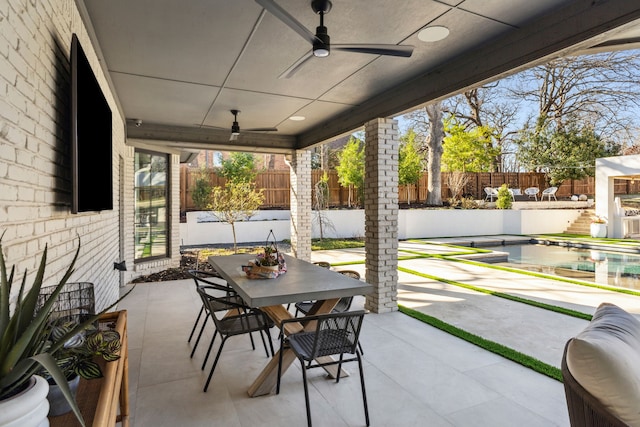 view of patio featuring outdoor dining area, a fenced backyard, a fenced in pool, and ceiling fan