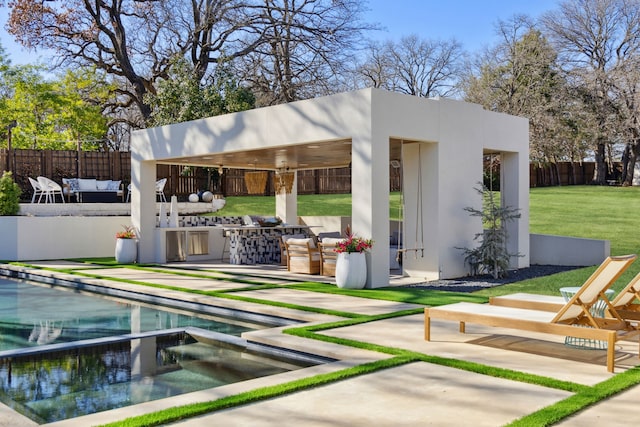 exterior space with a pool with connected hot tub, fence, a lawn, an outdoor hangout area, and a patio