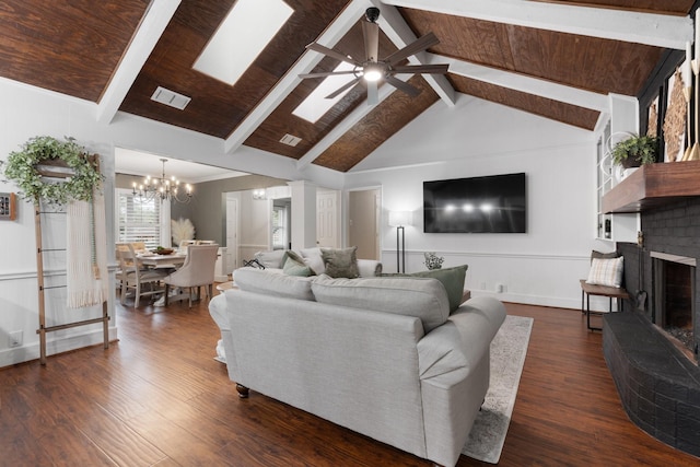 living area with a fireplace, visible vents, dark wood-type flooring, and beamed ceiling