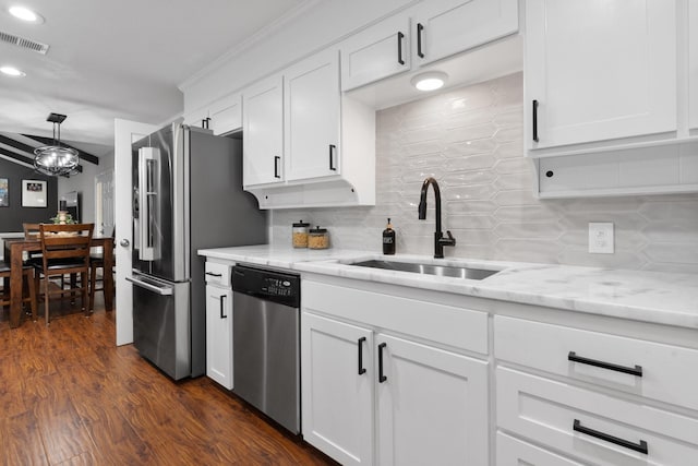 kitchen featuring stainless steel appliances, a sink, visible vents, log walls, and dark wood-style floors