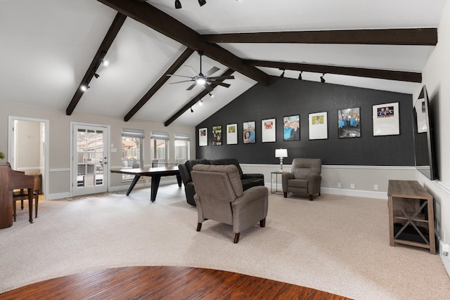 carpeted living area featuring lofted ceiling with beams, baseboards, and a ceiling fan