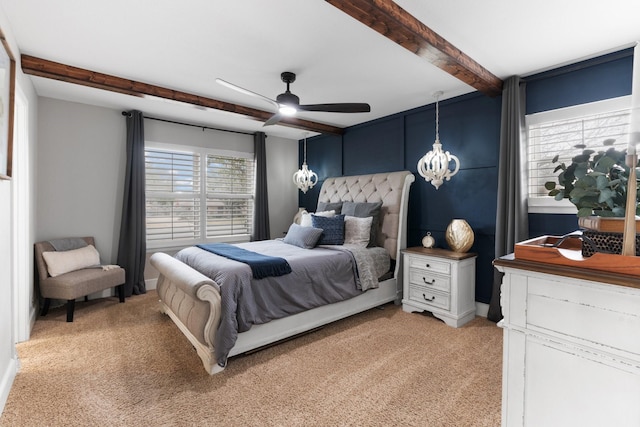 bedroom featuring ceiling fan with notable chandelier, beamed ceiling, and light colored carpet