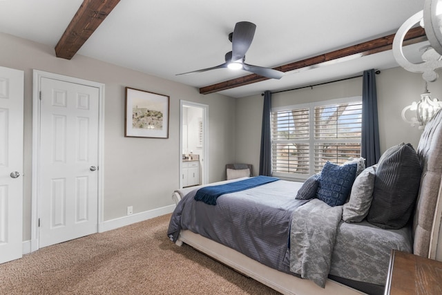 bedroom featuring baseboards, connected bathroom, ceiling fan, carpet floors, and beam ceiling