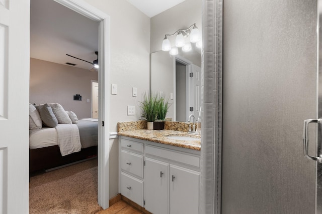 ensuite bathroom with ceiling fan, ensuite bathroom, vanity, visible vents, and a shower stall