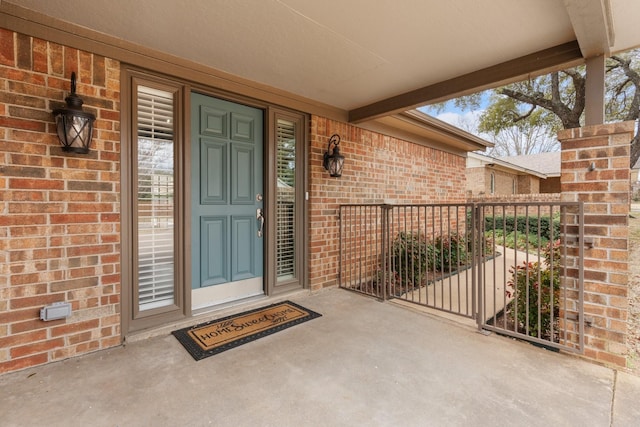 doorway to property with brick siding