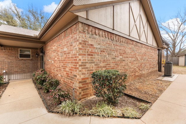 view of property exterior with brick siding and central AC