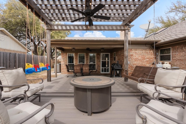 deck with ceiling fan, fence, a grill, and a pergola