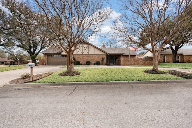 view of front of property featuring concrete driveway, a chimney, an attached garage, a front lawn, and brick siding