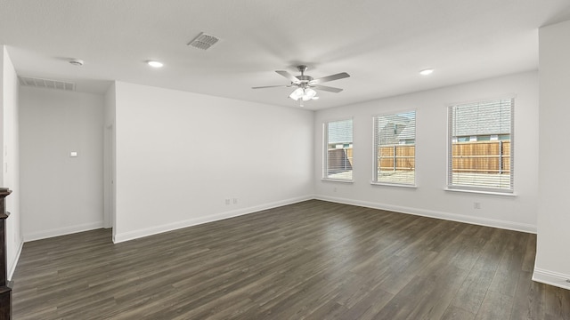 spare room with ceiling fan, baseboards, dark wood-style flooring, and visible vents