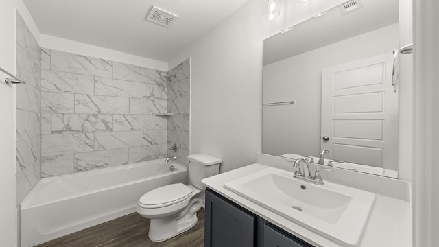 bathroom featuring wood finished floors, visible vents, toilet, and vanity