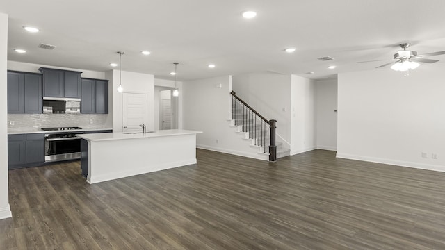 kitchen featuring oven, dark wood finished floors, recessed lighting, light countertops, and gas stovetop