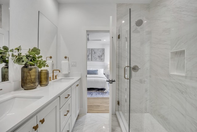 ensuite bathroom featuring ensuite bath, a marble finish shower, and a sink