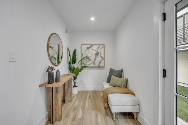 sitting room with light wood finished floors, baseboards, visible vents, and recessed lighting