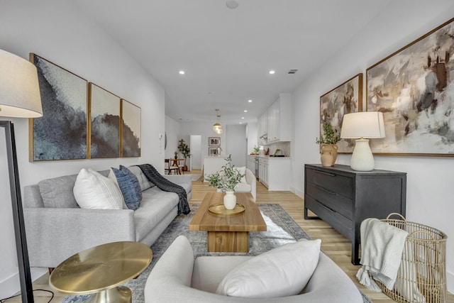 living area featuring recessed lighting, visible vents, and light wood-style floors