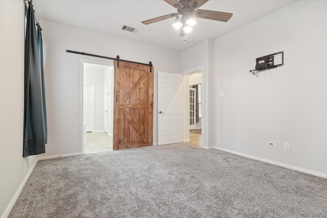 1931 Antebellum Ct, Savannah, TX 76227 - unfurnished bedroom featuring a barn door, baseboards, visible vents, and light colored carpet