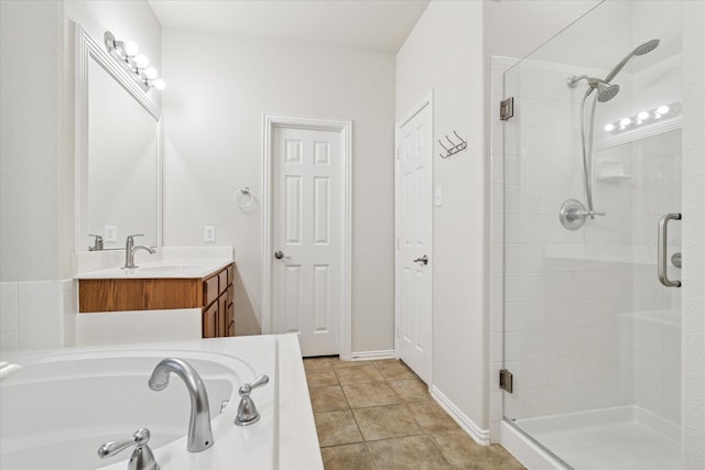 full bath with a garden tub, a shower stall, tile patterned flooring, and vanity