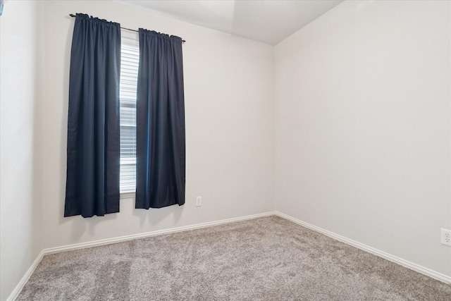 carpeted spare room with baseboards