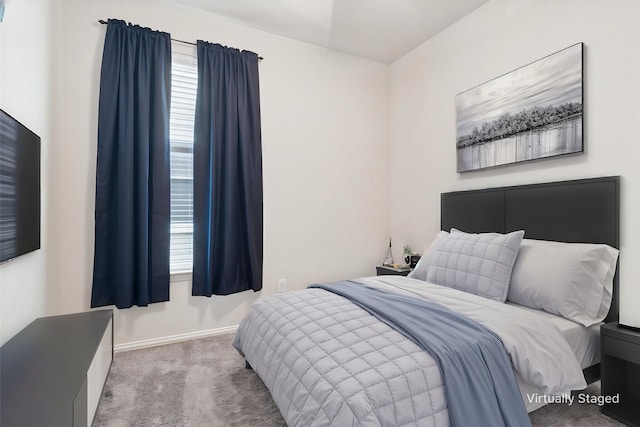 carpeted bedroom featuring baseboards