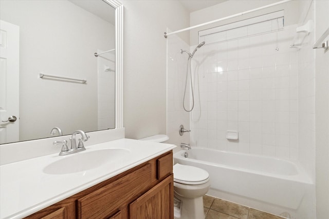 bathroom featuring toilet, tile patterned flooring, vanity, and bathing tub / shower combination