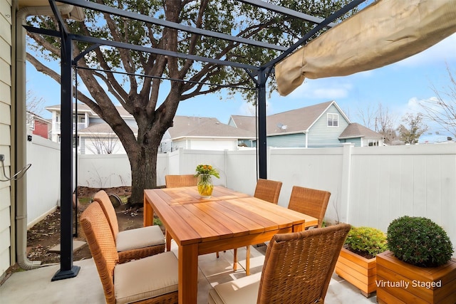 view of patio featuring outdoor dining area, a fenced backyard, and a pergola