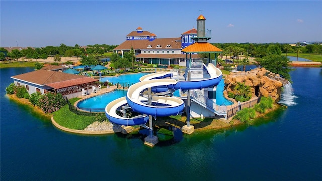 view of playground with a water view and a community pool