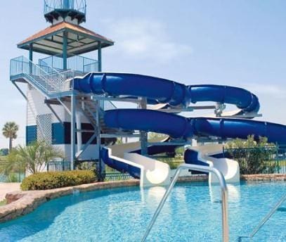 community pool featuring a water slide