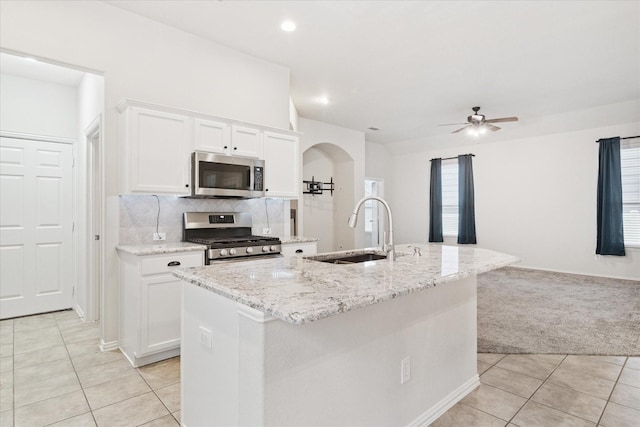 1931 Antebellum Ct, Savannah, TX 76227 - kitchen featuring a sink, light tile patterned floors, ceiling fan, light carpet, and stainless steel appliances