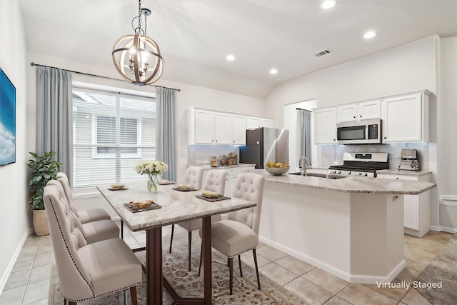 1931 Antebellum Ct, Savannah, TX 76227 - kitchen featuring decorative backsplash, an inviting chandelier, white cabinets, appliances with stainless steel finishes, and visible vents