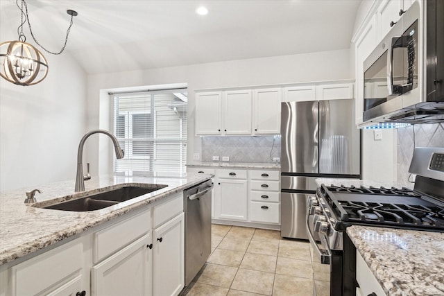 kitchen with decorative backsplash, appliances with stainless steel finishes, white cabinets, a sink, and light tile patterned flooring