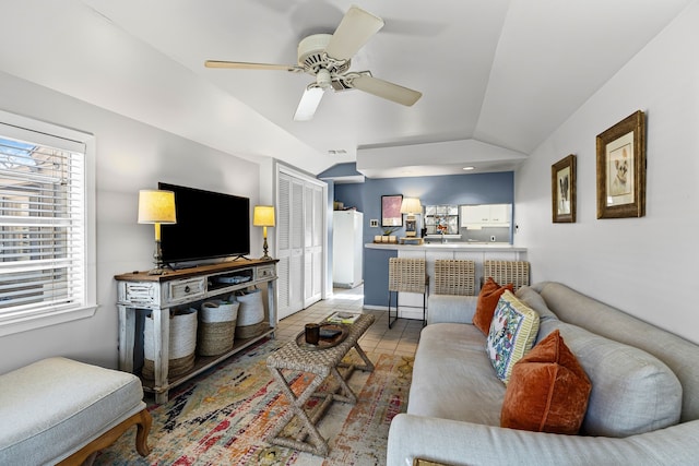 living room with lofted ceiling, tile patterned flooring, and a ceiling fan