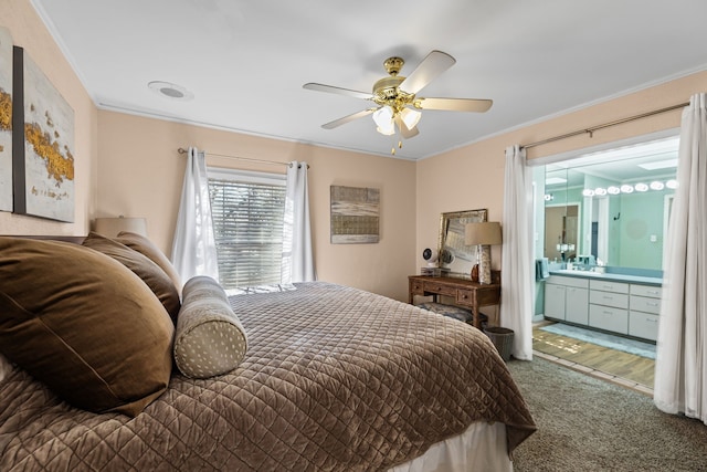 bedroom featuring ensuite bathroom, ornamental molding, carpet, and a ceiling fan