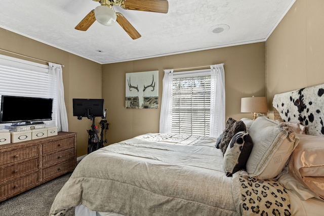 bedroom featuring crown molding, a ceiling fan, and carpet flooring