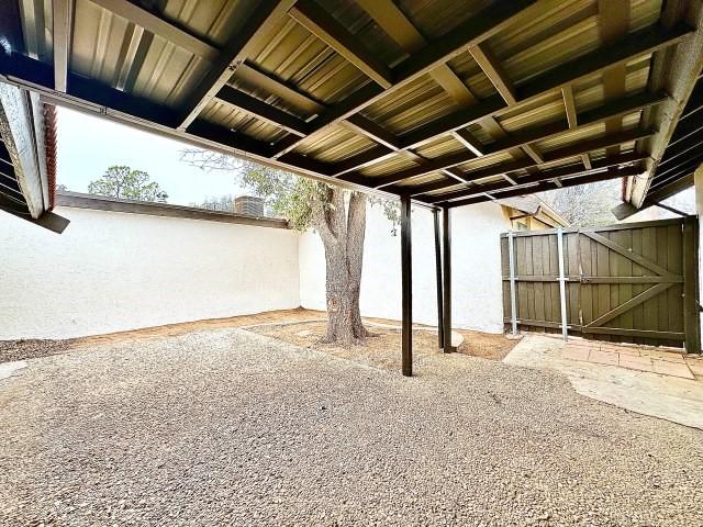 view of patio with fence and a gate