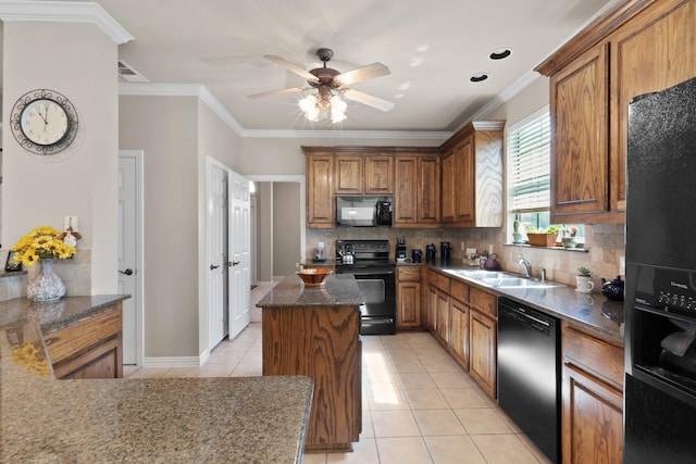 kitchen featuring light tile patterned floors, backsplash, black appliances, brown cabinetry, and crown molding