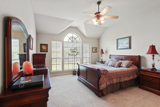 bedroom with light carpet, vaulted ceiling, and a ceiling fan