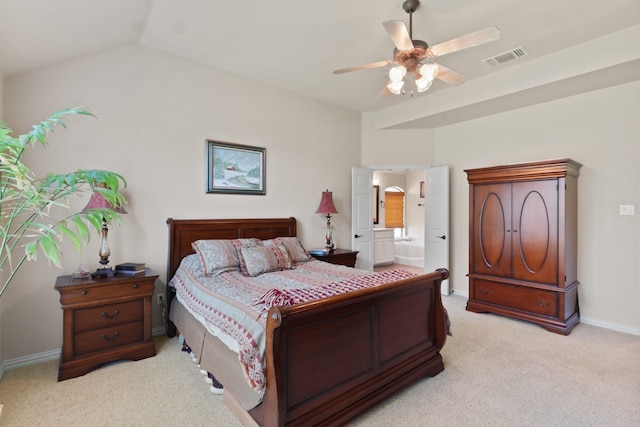 bedroom featuring light carpet, visible vents, baseboards, ensuite bath, and vaulted ceiling