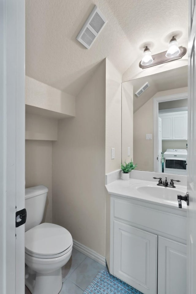 bathroom featuring toilet, a textured ceiling, tile patterned flooring, and visible vents