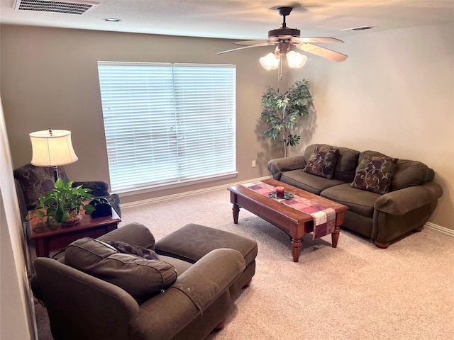 carpeted living room with visible vents, ceiling fan, and baseboards