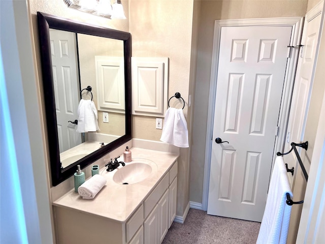 bathroom featuring baseboards and vanity