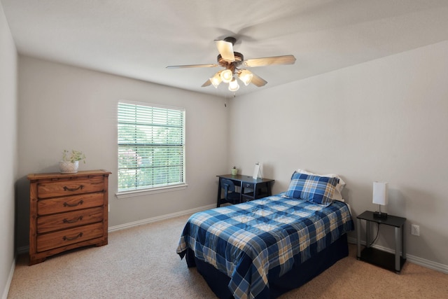 carpeted bedroom featuring ceiling fan and baseboards