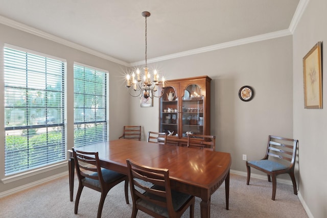 dining area featuring light carpet, crown molding, a chandelier, and baseboards