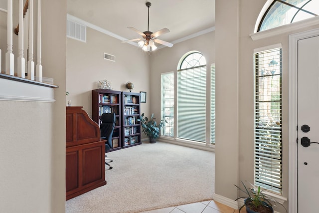 tiled office space with carpet floors, visible vents, ornamental molding, and ceiling fan