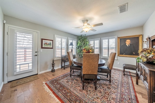 dining area featuring a wealth of natural light, visible vents, baseboards, and light wood-style floors